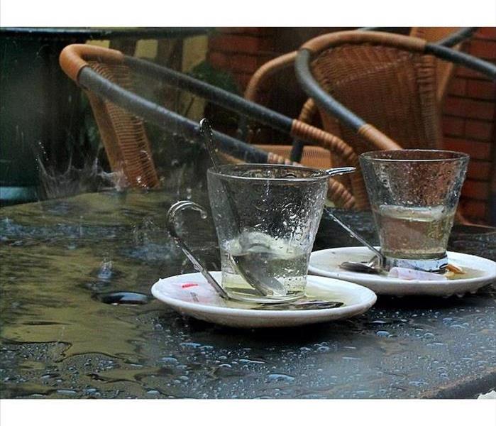 cups on table with pooling water around